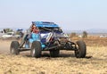 Forty Five degree close-up view of Speeding Blue Bat Spec 0 rally car